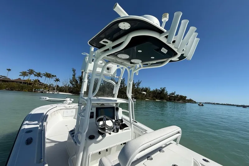  Yacht Photos Pics 2017 Yellowfin 26 Hybrid boat on calm water with clear blue sky.