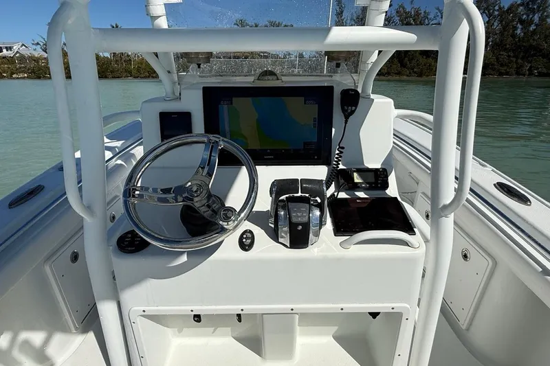  Yacht Photos Pics 2017 Yellowfin 26 Hybrid boat console with steering wheel and navigation equipment.