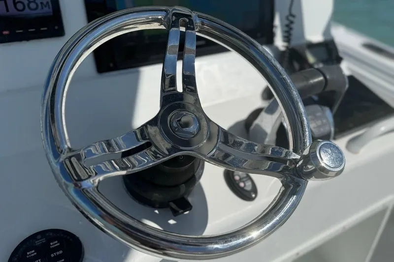  Yacht Photos Pics Steering wheel of 2017 Yellowfin 26 Hybrid boat, close-up view.