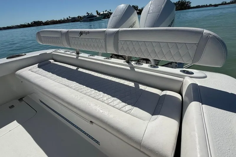  Yacht Photos Pics 2017 Yellowfin 26 Hybrid boat with white cushioned seating and dual Mercury engines.