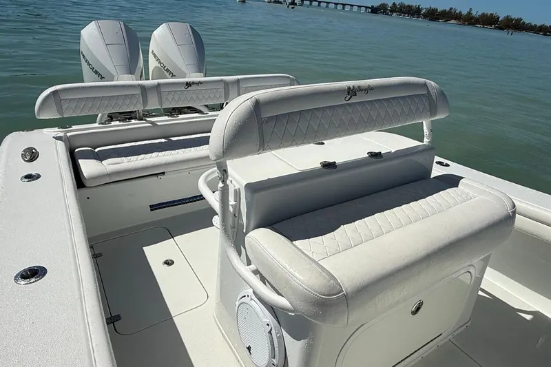  Yacht Photos Pics 2017 Yellowfin 26 Hybrid boat with dual Mercury engines on calm water.