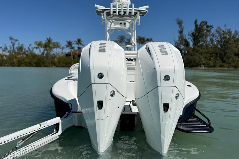  Yacht Photos Pics 2017 Yellowfin 26 Hybrid boat with dual outboard engines on calm water.