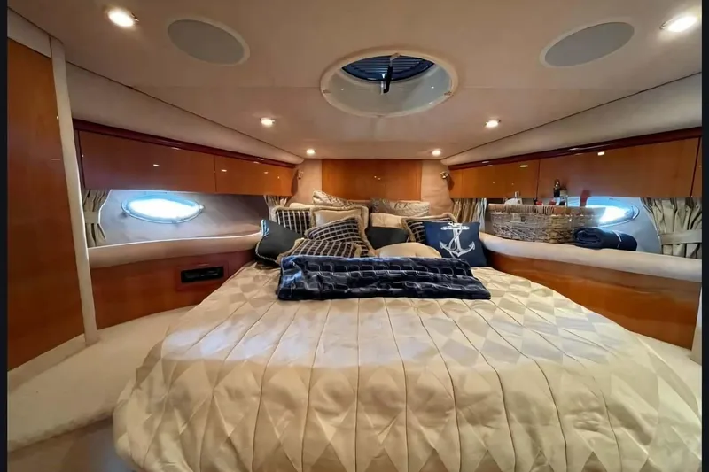  Yacht Photos Pics Luxurious cabin interior of 2004 Sunseeker Predator 56 yacht with elegant bedding and decor.