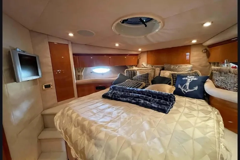  Yacht Photos Pics Luxurious cabin interior of 2004 Sunseeker Predator 56 yacht with plush bedding and decor.