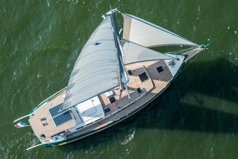 Jaleo Yacht Photos Pics Aerial view of 2019 Puffin 50 sailboat on green water, showcasing deck and sails.
