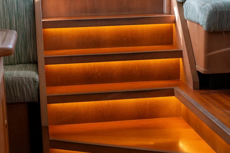 Jaleo Yacht Photos Pics Wooden stairs with warm LED lighting on a Puffin 50 yacht, 2019 model.