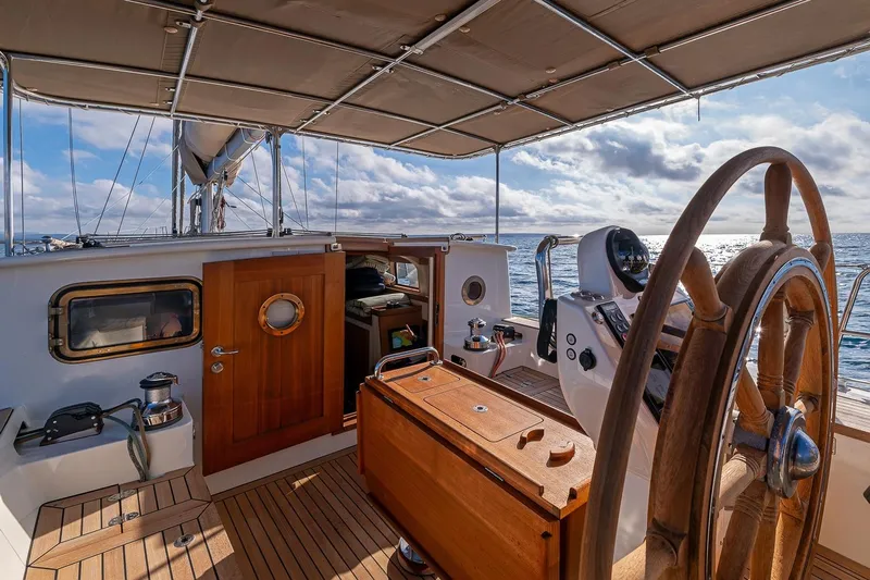 Jaleo Yacht Photos Pics Sailing yacht Puffin 50 cockpit with wooden wheel, ocean view, and canopy, 2019 model.