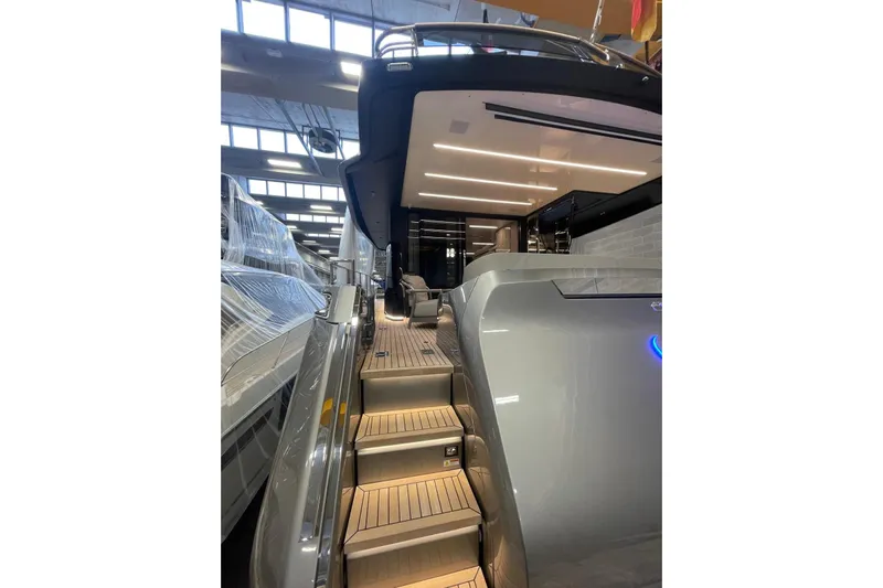  Yacht Photos Pics 2024 Cranchi 67 Sessantasette Fly yacht interior with illuminated stairs and modern design.