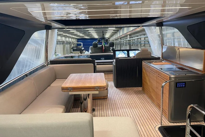  Yacht Photos Pics Luxurious interior of 2024 Cranchi 67 Sessantasette Fly yacht with modern kitchen and seating area.