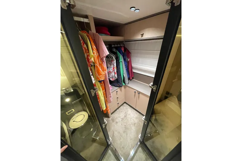  Yacht Photos Pics Luxurious closet in 2024 Cranchi 67 Sessantasette Fly yacht with hanging clothes.