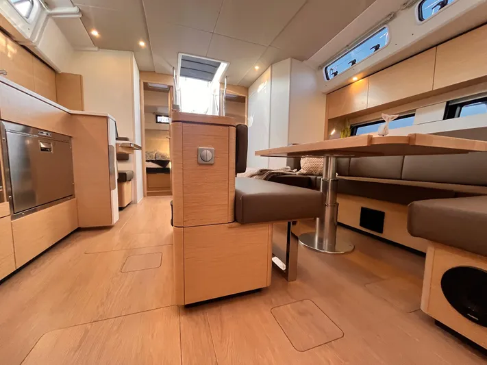 Hans Off Yacht Photos Pics Modern interior of 2023 Hanse 460 yacht with sleek wood finishes and spacious seating area.
