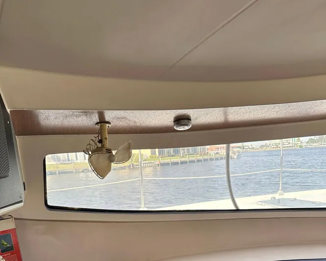 Felice Yacht Photos Pics Interior view of a 1998 Fountaine Pajot Athena 38 catamaran with a window overlooking the water.