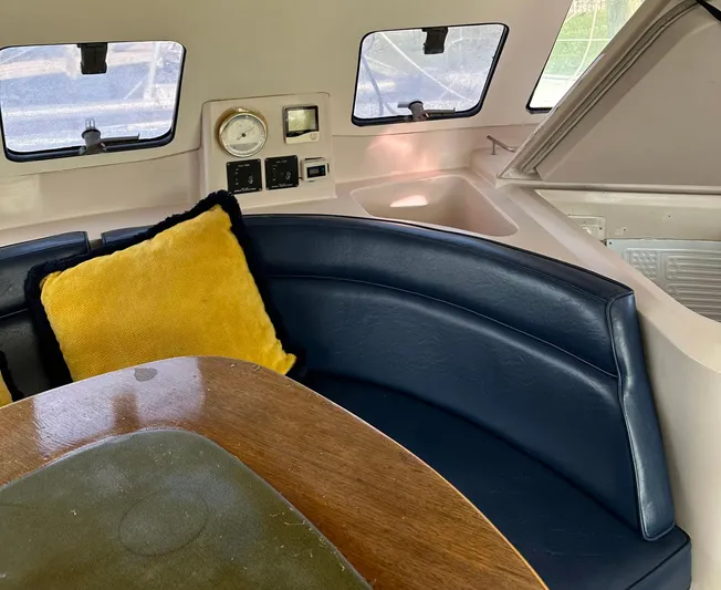 Felice Yacht Photos Pics Interior of 1998 Fountaine Pajot Athena 38 with blue seating and yellow cushion.