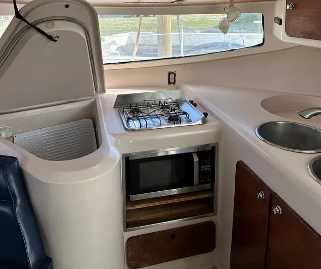 Felice Yacht Photos Pics 1998 Fountaine Pajot Athena 38 yacht kitchen with stove, microwave, and sink.
