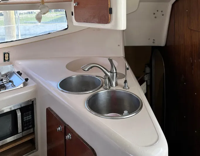 Felice Yacht Photos Pics Galley kitchen of 1998 Fountaine Pajot Athena 38 catamaran with dual sinks and microwave.