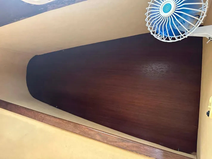 Felice Yacht Photos Pics Interior cabin of 1998 Fountaine Pajot Athena 38 with wooden paneling and small fan.