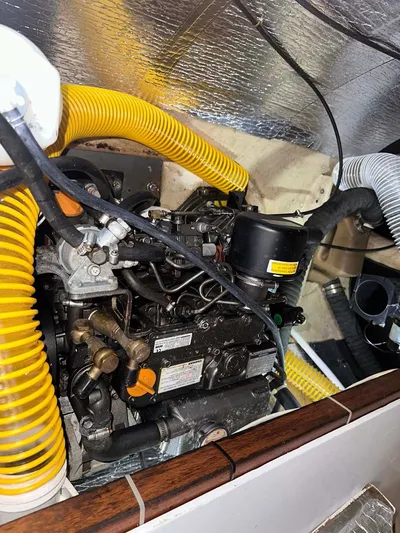 Felice Yacht Photos Pics Engine compartment of a 1998 Fountaine Pajot Athena 38 catamaran with visible hoses and components.