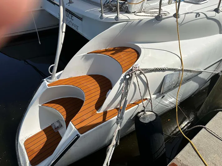 Felice Yacht Photos Pics 1998 Fountaine Pajot Athena 38 catamaran with teak deck, docked at a marina.