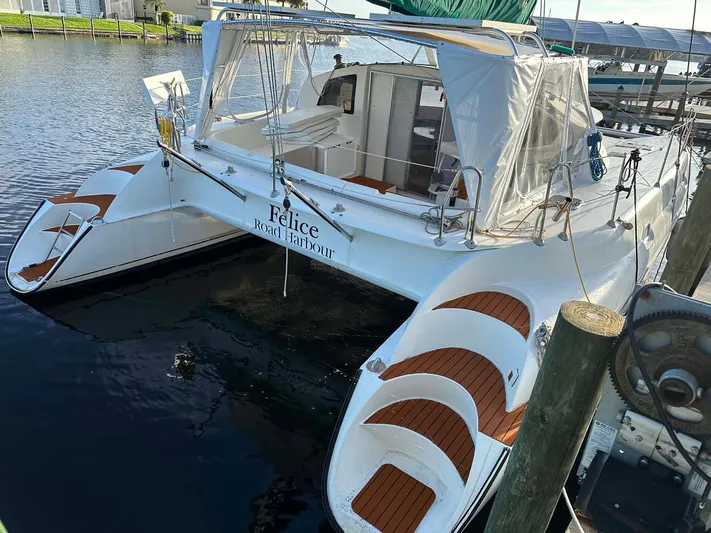 Felice Yacht Photos Pics 1998 Fountaine Pajot Athena 38 catamaran docked, featuring spacious deck and covered cockpit.