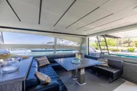 Luxurious interior of 2016 Pershing 82 yacht with modern seating and large windows.