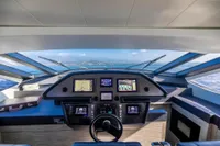 Helm of 2016 Pershing 82 yacht with navigation screens and ocean view.