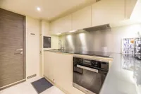 Modern kitchen interior on 2016 Pershing 82 yacht, featuring sleek cabinetry and stainless steel appliances.