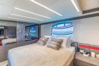 Luxurious bedroom interior of 2016 Pershing 82 yacht with modern design and ocean view.