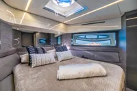 Luxurious interior of 2016 Pershing 82 yacht with elegant bedding and scenic window view.