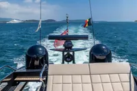 Luxury Pershing 82 yacht cruising on open sea, 2016 model, with flags waving.