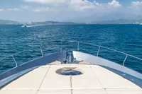 Luxurious 2016 Pershing 82 yacht cruising on open blue sea under clear skies.