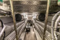 Engine room of a 2016 Pershing 82 yacht, showcasing dual engines and mechanical components.