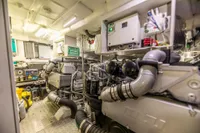 Engine room of a 2016 Pershing 82 yacht, showcasing advanced machinery and equipment.