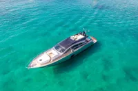 Luxurious 2016 Pershing 82 yacht cruising in clear turquoise waters.