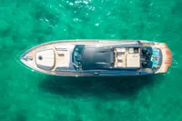 Aerial view of 2016 Pershing 82 yacht on turquoise water.