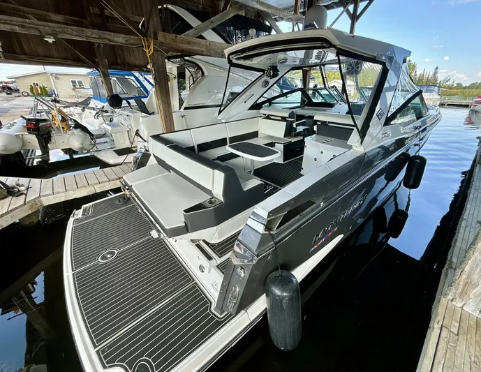  Yacht Photos Pics 2017 Monterey 378 Super Express boat docked in a marina, showcasing sleek design and spacious seating.