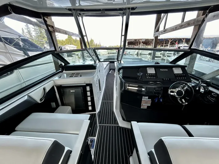  Yacht Photos Pics Interior view of 2017 Monterey 378 Super Express boat cockpit with modern controls and seating.