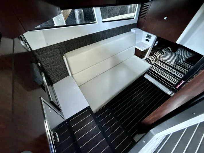  Yacht Photos Pics Interior of 2017 Monterey 378 Super Express yacht with seating and striped bedding.