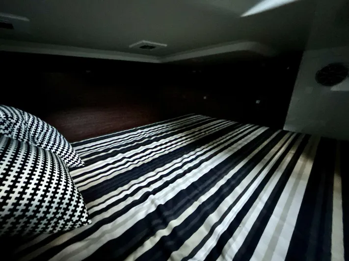  Yacht Photos Pics Interior cabin of 2017 Monterey 378 Super Express with striped bedding and patterned pillows.