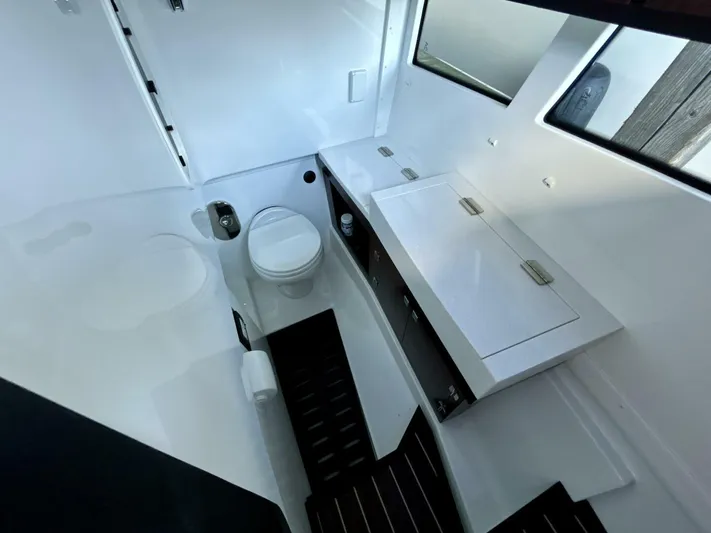 Yacht Photos Pics Interior of 2017 Monterey 378 Super Express boat bathroom with toilet and storage cabinets.