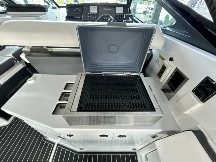  Yacht Photos Pics 2017 Monterey 378 Super Express yacht interior with open grill and control panel.