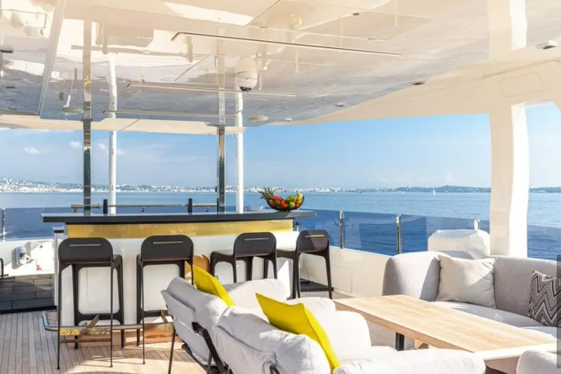  Yacht Photos Pics Luxurious 2018 Customline Navetta 33 yacht deck with bar and seating, overlooking serene ocean view.