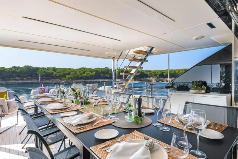  Yacht Photos Pics Luxurious dining setup on 2018 Customline Navetta 33 yacht with scenic ocean view.