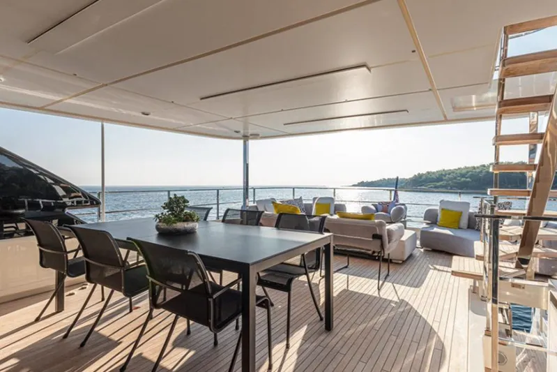  Yacht Photos Pics Luxurious 2018 Customline Navetta 33 yacht deck with seating, dining area, and ocean view.