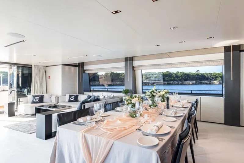  Yacht Photos Pics Luxurious interior of 2018 Customline Navetta 33 yacht with elegant dining setup and scenic views.