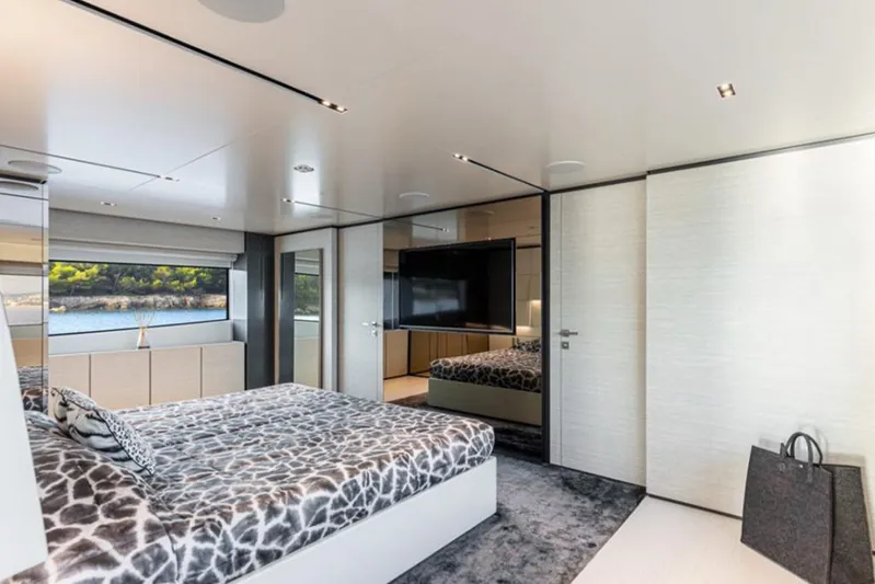  Yacht Photos Pics Luxurious bedroom interior of 2018 Customline Navetta 33 yacht with modern decor and scenic view.