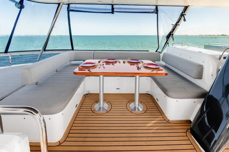 Viakarey Yacht Photos Pics Luxurious 2023 Sirena 58 yacht deck with elegant dining setup and ocean view.