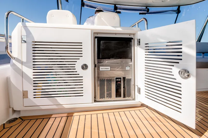 Viakarey Yacht Photos Pics Outdoor kitchenette on 2023 Sirena 58 yacht with ice maker and storage cabinets.