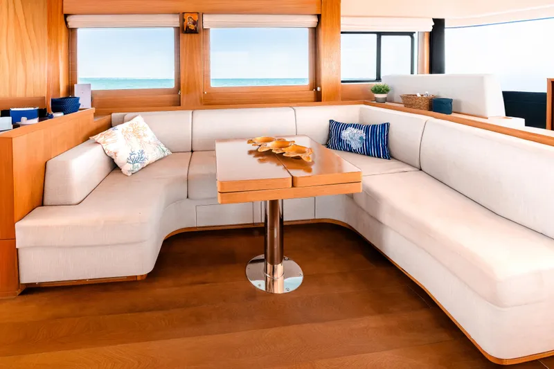 Viakarey Yacht Photos Pics Luxurious interior of 2023 Sirena 58 yacht with elegant seating and ocean view.