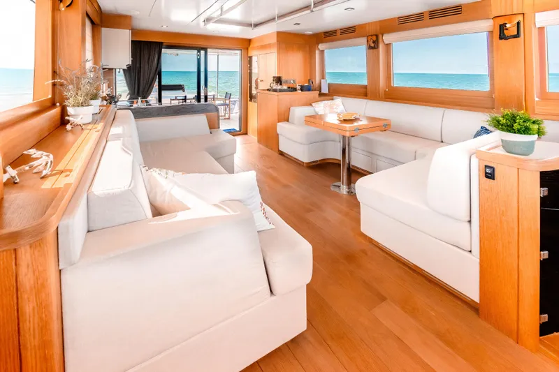 Viakarey Yacht Photos Pics Luxurious interior of 2023 Sirena 58 yacht with elegant seating and ocean view.