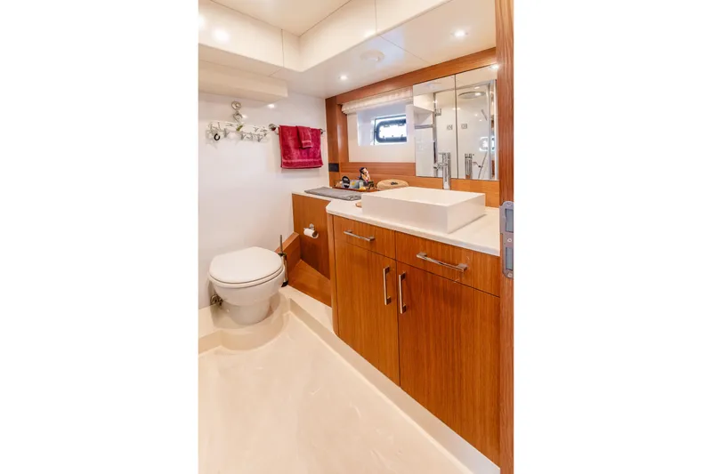 Viakarey Yacht Photos Pics Luxurious bathroom interior of 2023 Sirena 58 yacht with modern fixtures and wooden cabinetry.